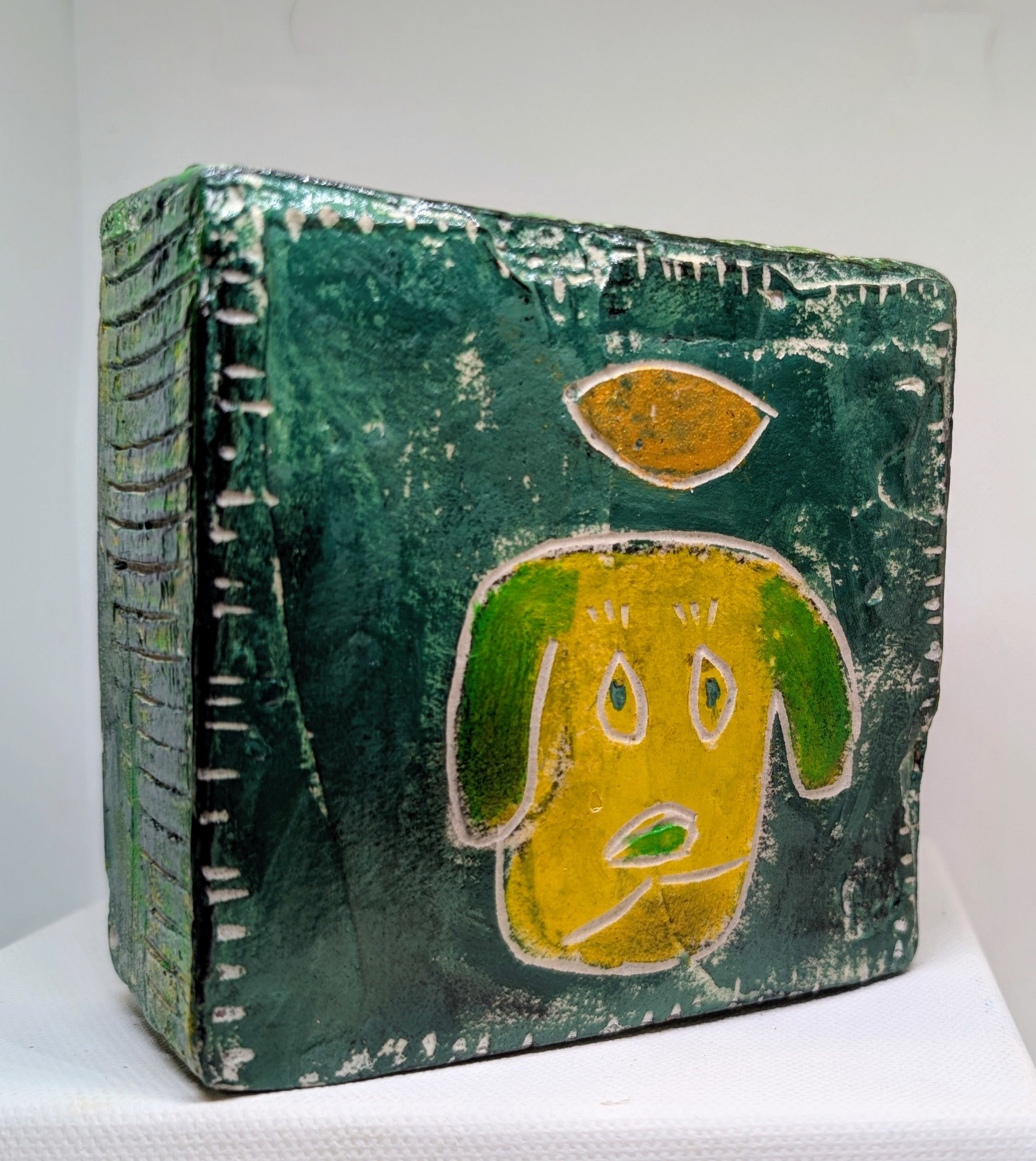 Yellow dog icon:  Textured dog painted block on upcycled material