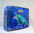 Blue bird icon:  Textured bird painted block on upcycled material