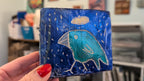 Blue bird icon:  Textured bird painted block on upcycled material